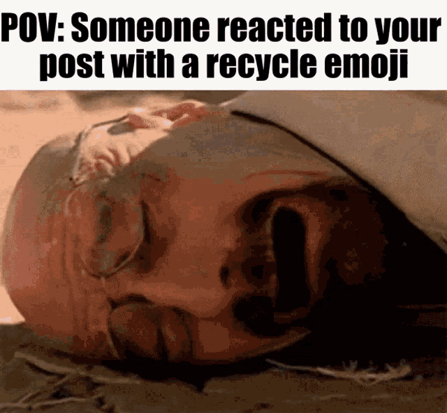 a man laying on the ground with a recycle emoji on his post