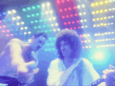 a man playing a guitar and another man playing drums