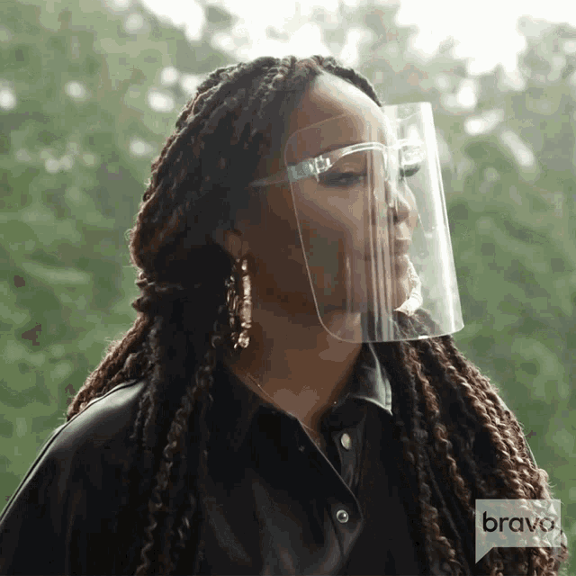 a woman wearing a face shield with the word bravo on the bottom right