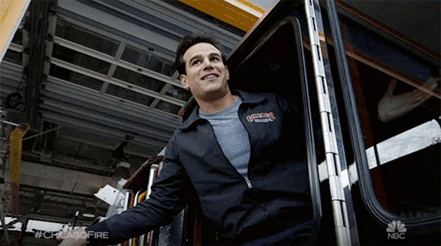 a man wearing a jacket that says chicago fire is smiling
