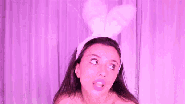a young woman is wearing bunny ears and looking up at the camera .