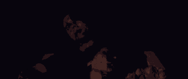 a ghost is standing in front of a burning fire in the dark