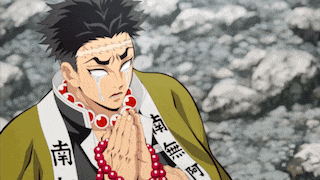 a man with chinese writing on his sleeve is praying with his hands together