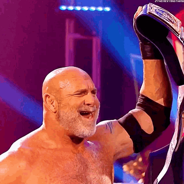 a bald man with a beard is holding a trophy in his hand