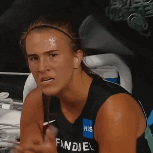 a woman wearing a black tank top that says fandel