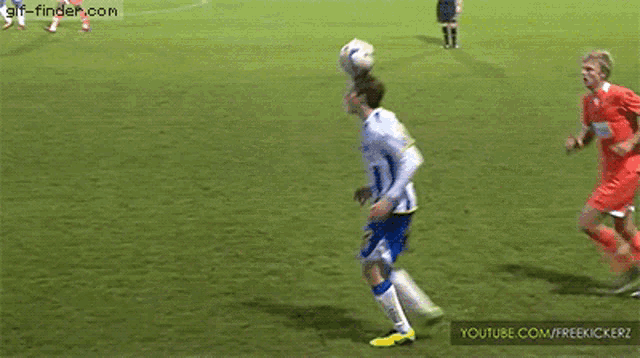 a soccer player with the number 2 on his back is kicking the ball