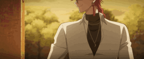 a man with red hair and a white shirt is smiling