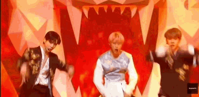 a group of men are dancing on a stage in front of a tiger .