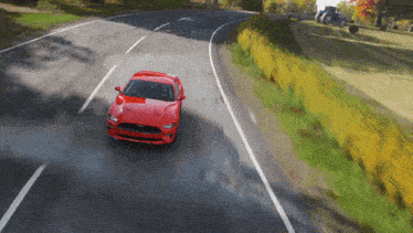 a red ford mustang driving down a road