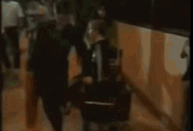 a woman in a green sweater is dancing in front of a bus .