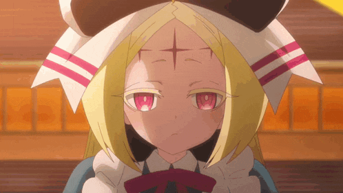 a little girl with a cross on her forehead