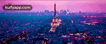an aerial view of the eiffel tower at night with the words kulfyapp.com below it