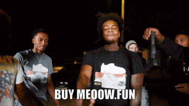 a man wearing a black shirt that says buy meoow fun