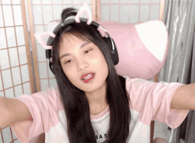 a girl wearing headphones and a shirt that says " babe "