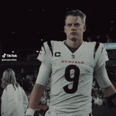 a man in a bengals jersey with the number 9 on his chest