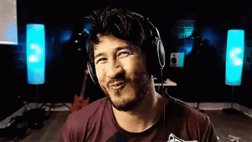 a man is wearing headphones and making a funny face .