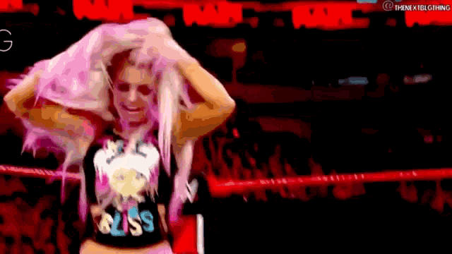 a woman with pink hair and a shirt that says bliss