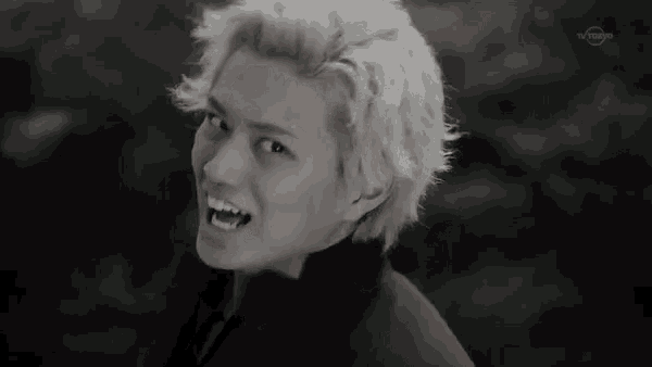 a black and white photo of a young man with tv tokyo written on the bottom right corner