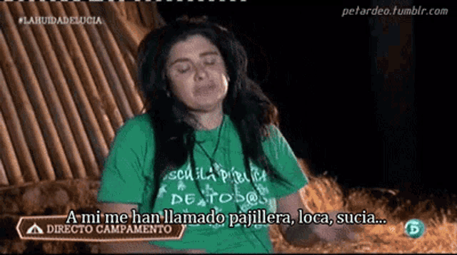 a woman wearing a green shirt that says a mi me han llamado pajillera loca sucia
