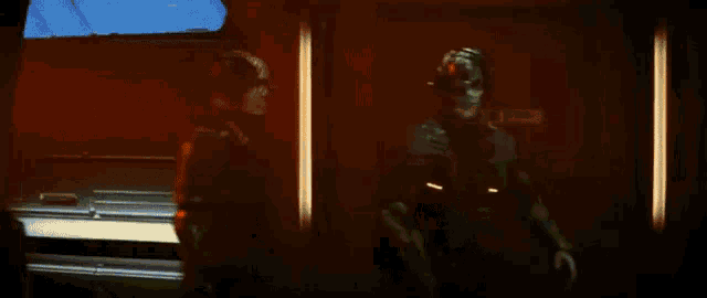 a group of people are standing in a room with a skeleton in the background .