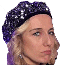 a close up of a woman wearing a purple hat .
