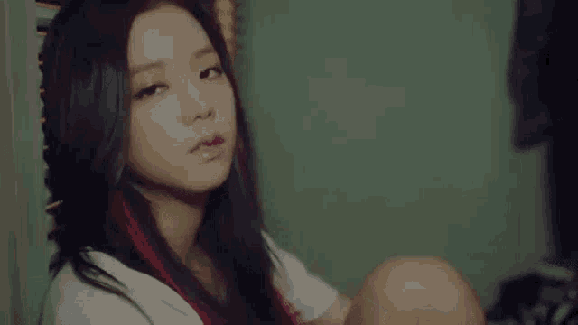 a close up of a woman sitting on the floor with her legs crossed .