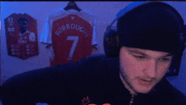 a man wearing headphones and a beanie has the number 7 on his jersey