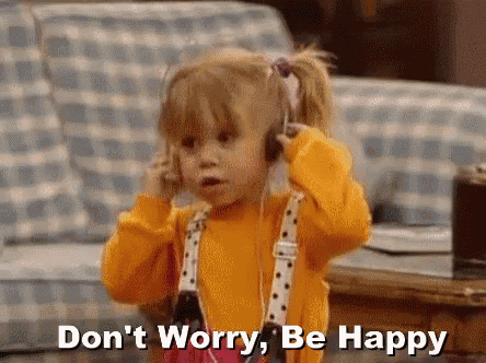 a little girl wearing headphones is talking on a cell phone and says `` don 't worry , be happy '' .