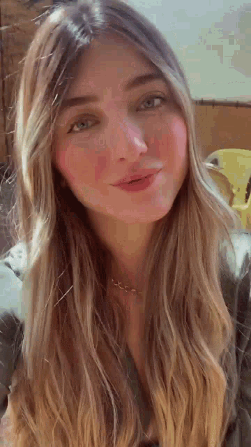 a close up of a woman 's face with long blonde hair .