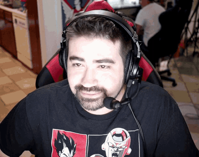 a man wearing headphones and a t-shirt with a picture of vegeta on it