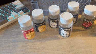 bottles of glucose ibuprofen and allergy are on a desk