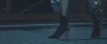 a person is standing in a dark room with a blue light coming out of their feet .
