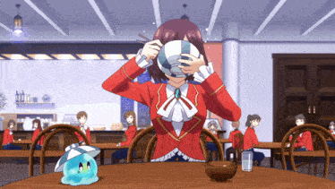 a girl in a red jacket is holding a bowl in front of her face