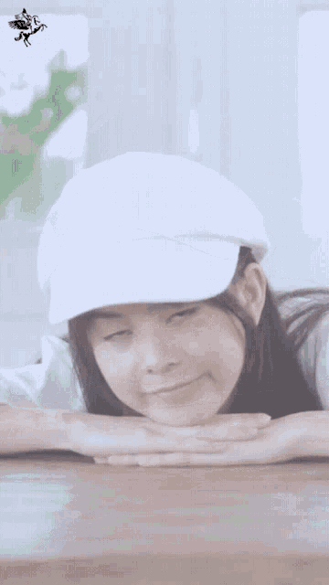 a girl wearing a white hat and a white shirt