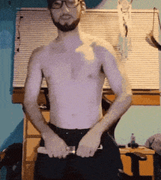 a shirtless man with glasses is holding a knife in his hands