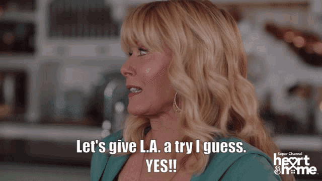 a man and a woman are sitting at a table and the man says let 's give l.a. a try