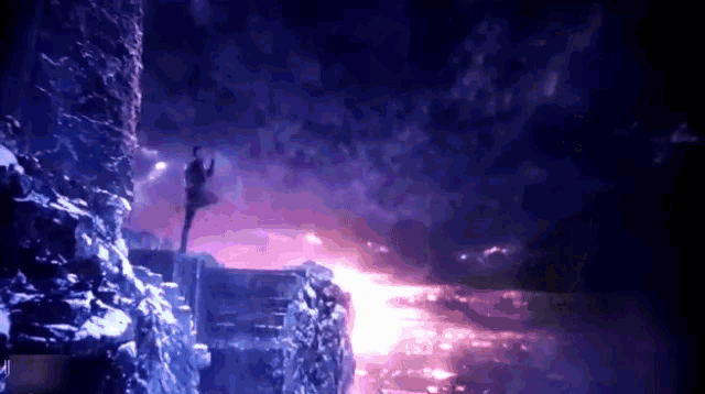 a person standing on a cliff with a purple background