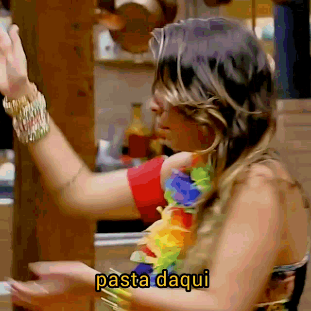 a woman wearing a lei and a bracelet is dancing with the words pasta daqui below her
