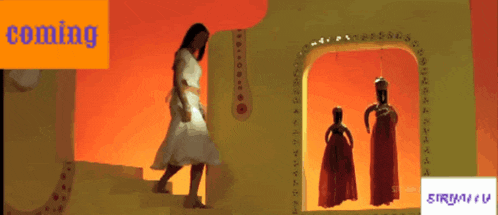 a woman in a white dress is standing in front of a window with the word coming on it