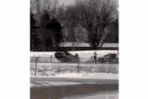 a car is going down a snowy road .