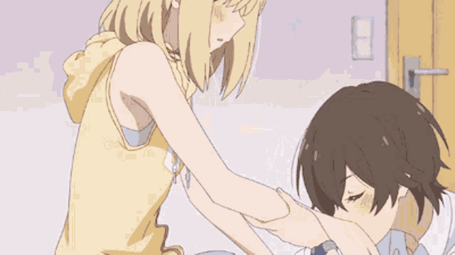 a girl in a yellow tank top is holding a boy in a white shirt