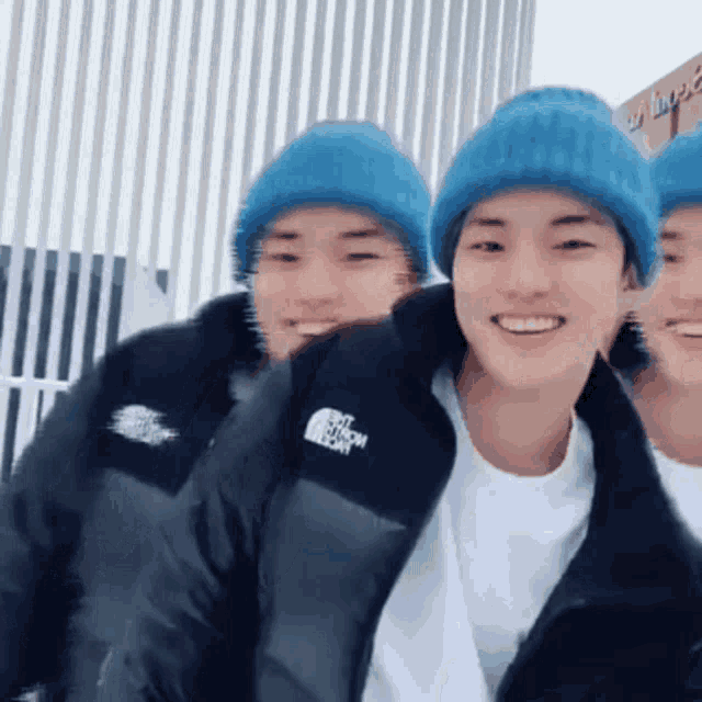 a man wearing a north face jacket is smiling