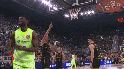 a basketball player in a neon green jersey with the number 18 on it