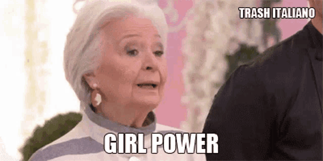 an elderly woman is talking to a man and says girl power .