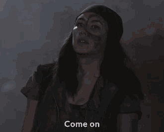 a woman says come on in a dark room with smoke behind her