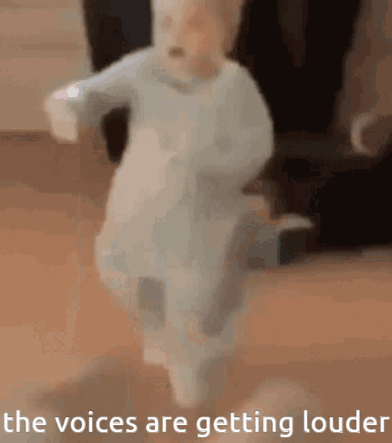 a baby is jumping in the air with the words the voices are getting louder below it