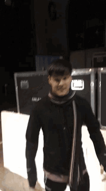 a person standing in front of a sign that says g.