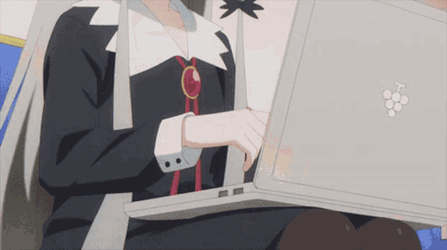 a girl with white hair is yawning in front of a computer
