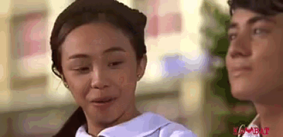 a man and a woman are standing next to each other . the woman is crying and the man is smiling .