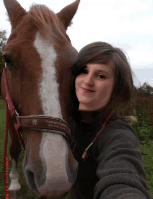 a woman taking a picture of herself with a horse on a photo taken on october 17th 2011